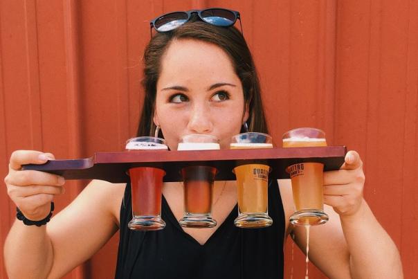 Woman with beer flight at Quattro Goomba's Brewery