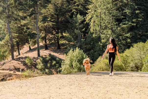 Woman walking her dog at Joaquin Miller Park in Oakland California