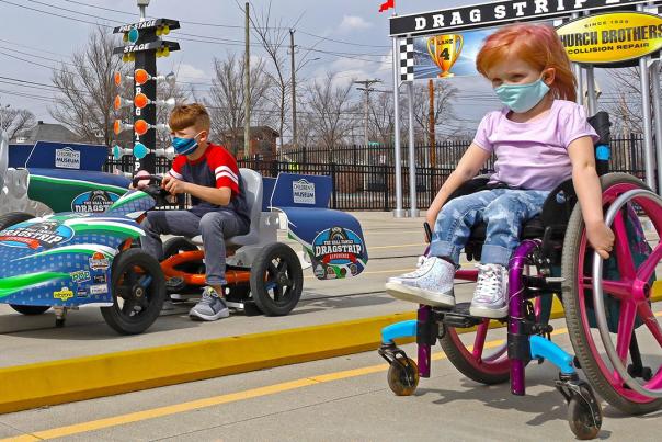 A girl in a wheelchair at the Children's Museum of Indianapolis drag strip