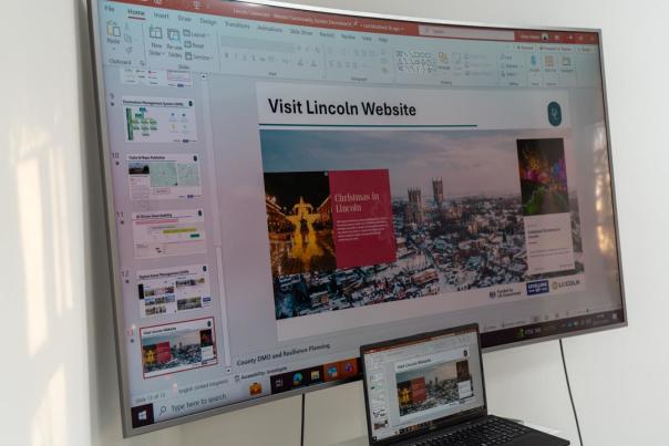 a screen showing a powerpoint presentation titled Visit Lincoln Website