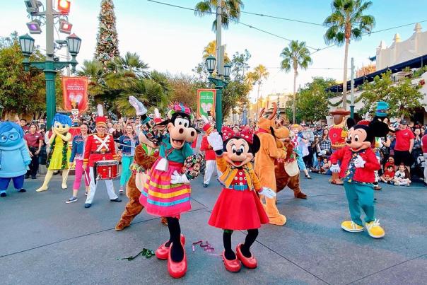 Image of Mickey and Minnie Mouse and friends dancing on Buena Vista Street in Disney California Adventure.