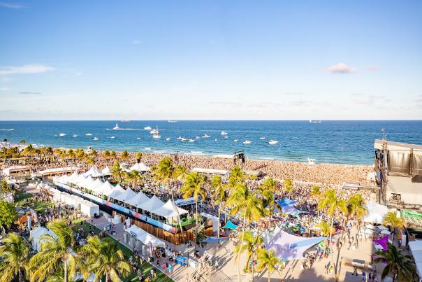 Aerial photo of crowds of listeners on Fort Lauderdale Beach with boats anchored in the waters off-shore