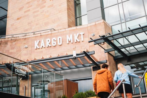 People walking up stairs to KARGO MKT