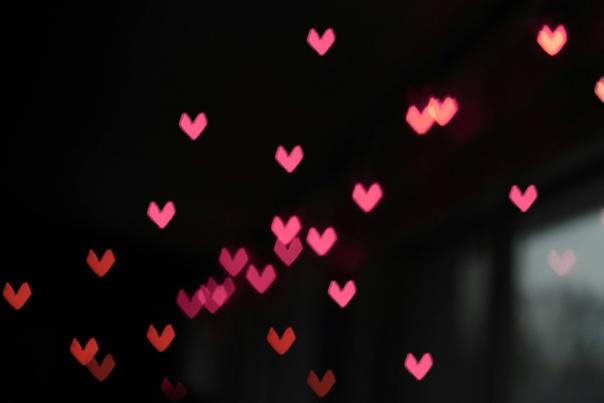 Photograph showing pink heart icons floating in the air