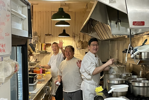 Three chefs preparing meals at Mrs. Riches Restaurant.