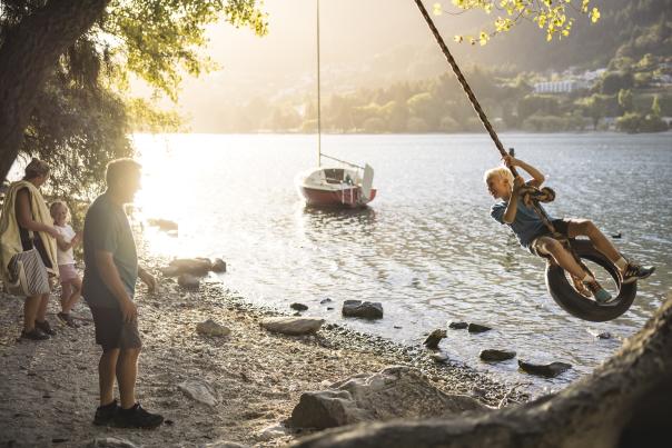 Family playing on rope swing in Queenstown Gardens
