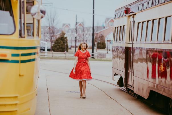 Jenna Zeihen walks between streetcars