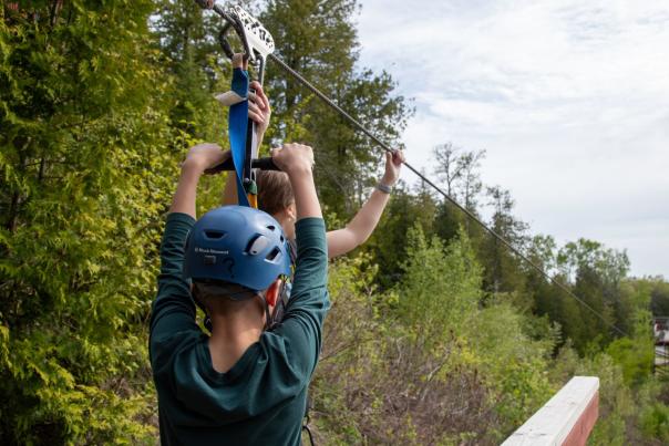 A boy ziplining in the Upper Peninsula of Michigan