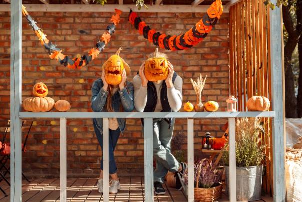 Couple posing with carved pumpkins