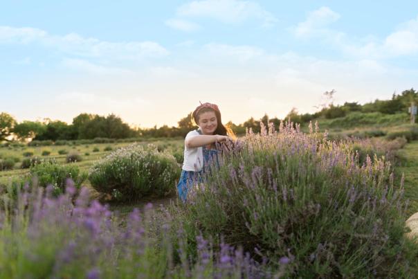Girl stands in a lavender field in the evening