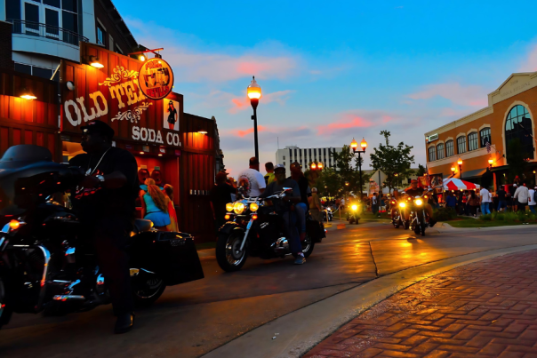 sunset colored sky over downtown street with motorcyles at muskegon rebel road festival