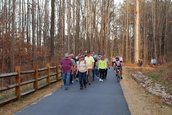 A group of people walking on the Sam's Branch Greenway during a 2022 event.