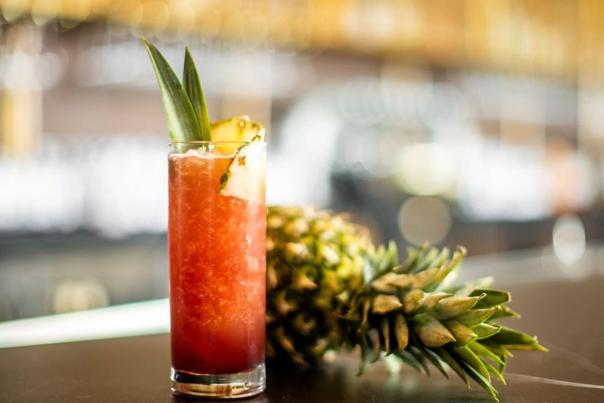 Adult beverage next to a pineapple