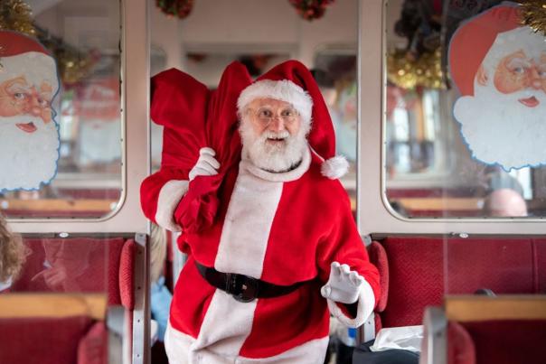 Santa walking down the aisle of an East Lancs Railway train