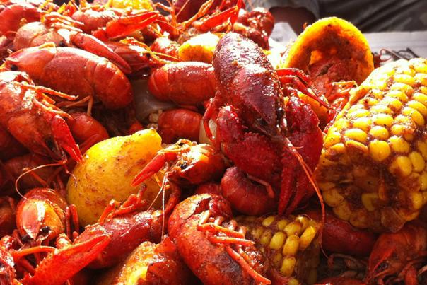 Tim's Rivershore Crawdad Festival photo of crawdads, corn and a Corona