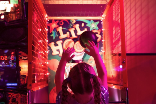 Child playing indoor arcade games at Happy Joes