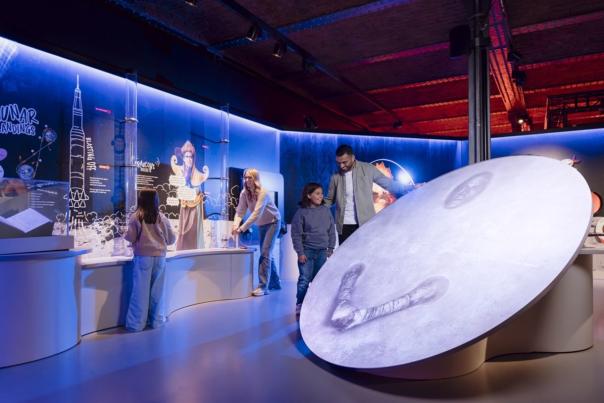 Family exploring space exhibition at Museum of Science and Industry.