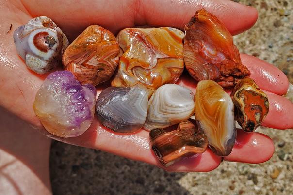 Agates and amethyst in hand
