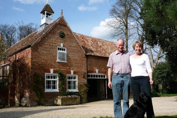 a man and a woman stood in front out Brackenborough Hall Coach House