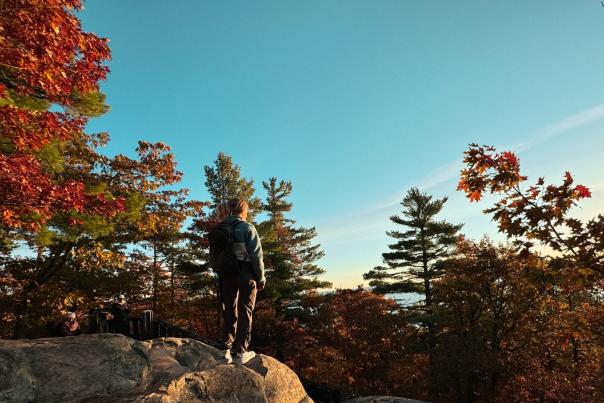Woman on a rocky overlook during fall color in the Upper Peninsula of Michigan