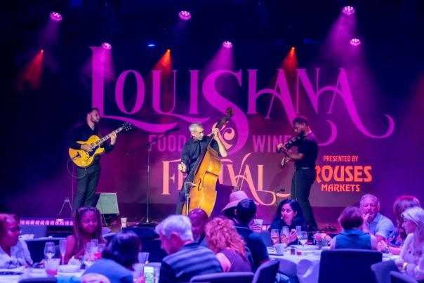 jazz musicians with guitar, cello, and violin perform during the sunday jazz brunch for the louisiana food and wine festival