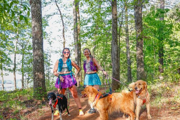 2 ladies hiking with dogs