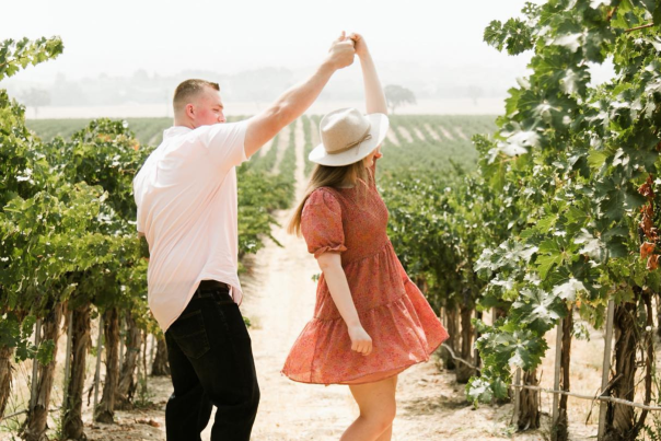 Couple dancing together in vineyard