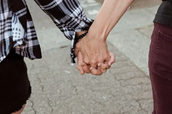 Two people holding hands.