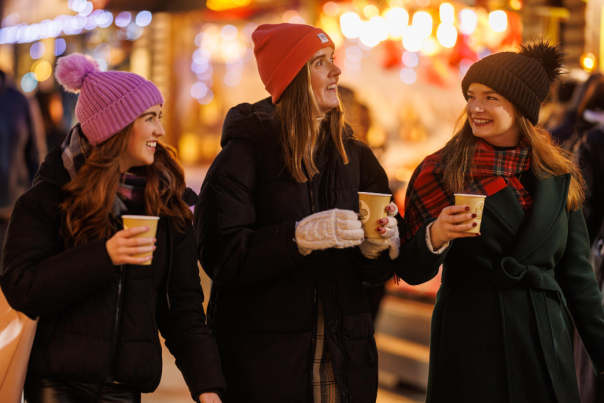 Girls drinking hot chocolate at Belfast Christmas markets.