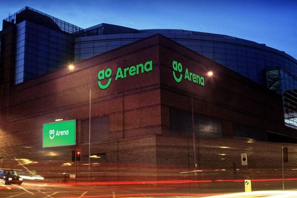 AO Arena at night with lights and car light trails