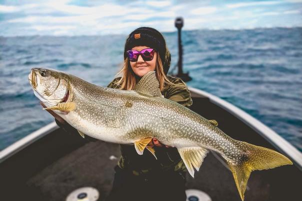 woman holding a huge fish on Lake Superior