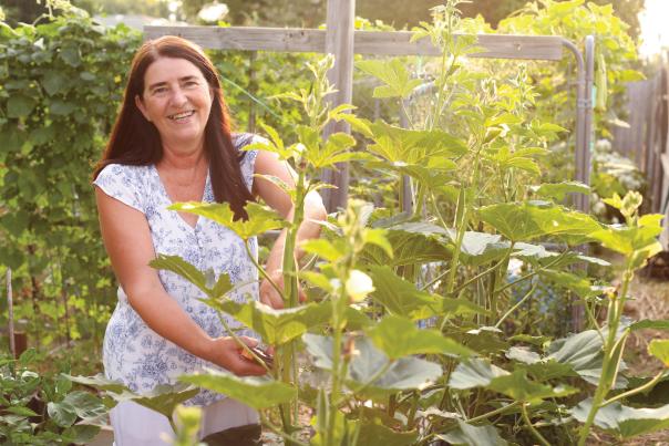 woman kneeling in a veggie garden