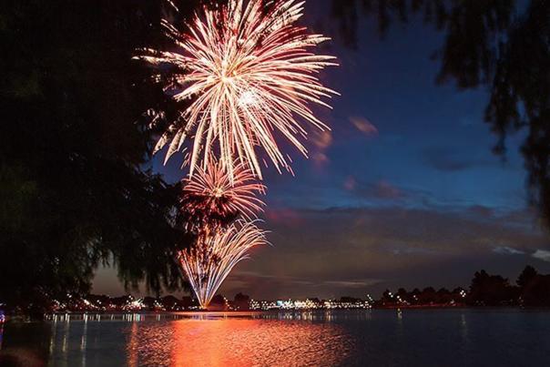 Fireworks going off over lake