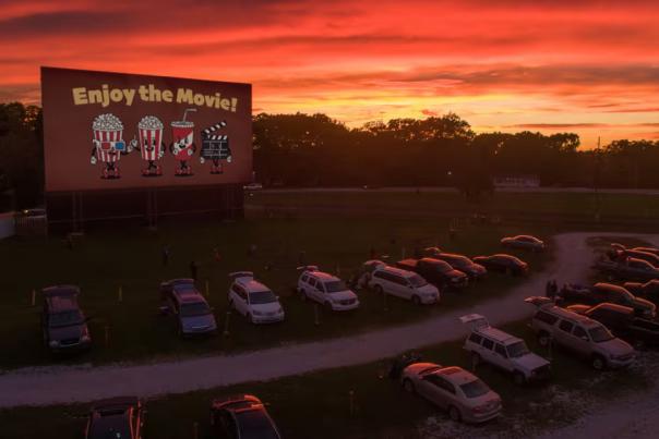 Cars at a drive-in theatre at sunset