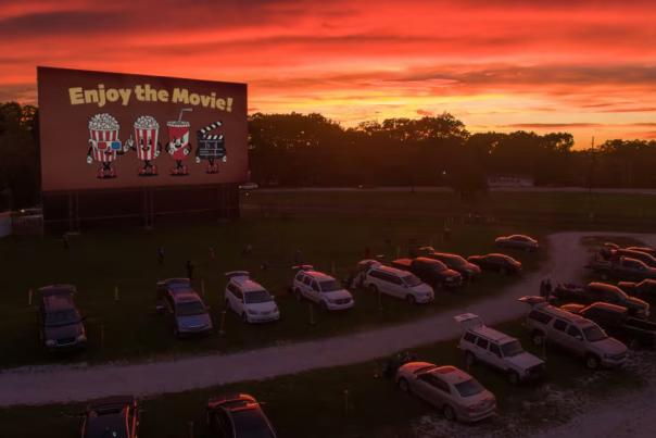 Cars at a drive-in theatre at sunset