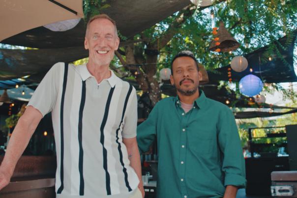 Benchmark owners Duane Greenleaf and Pedro Arizmendi standing proudly in front of their Santa Ana restaurant.