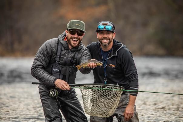Two fishermen celebrate a catch in the Poconos.