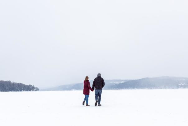 Couple on frozen lake holding hands