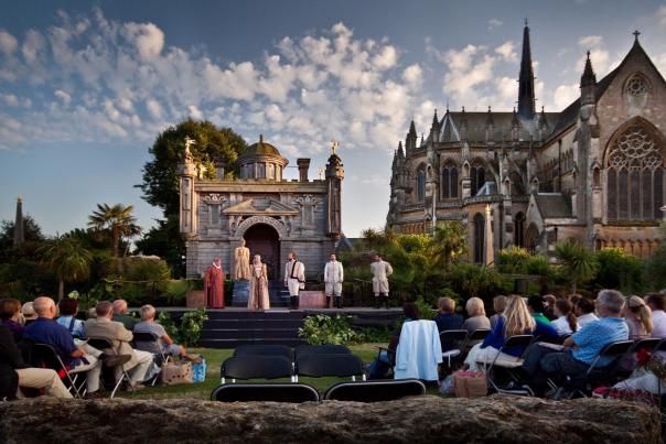 Audience watching Midsummer Shakespeare outdoor theatre performance in grounds of Arundel Castle
