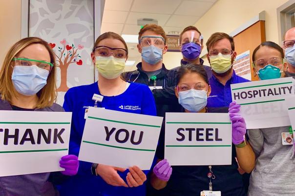 Nurses hold signs expressing Thanks
