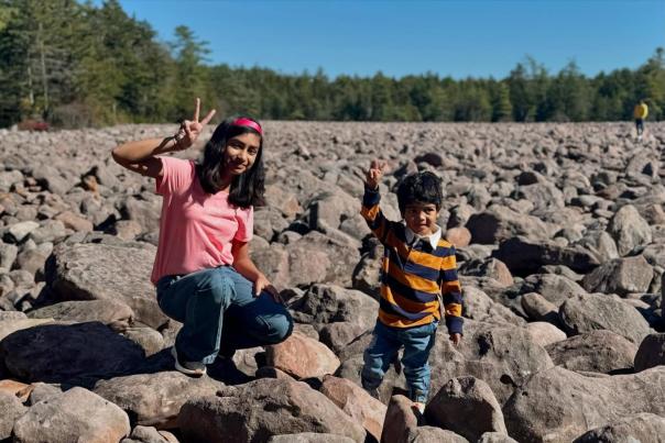 A boy and girl pose for a photo at Boulder Field at Hickory Run State Park in the Pocono Mountain.s