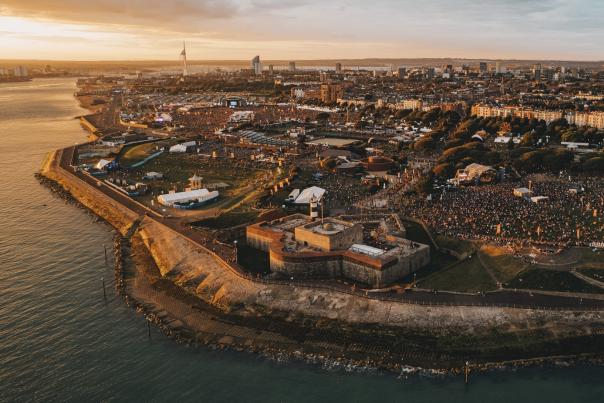 Aerial photograph showing the Victorious Festival site at the golden hour, with Southsea Castle in the foreground