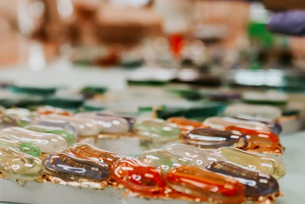 colorful pieces of glass placed on a canvas at lil art house