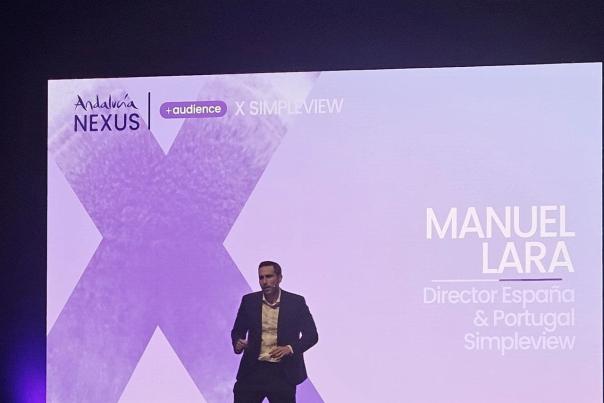 Manuel Lara of Simpleview, now part of Granicus, presenting on stage.