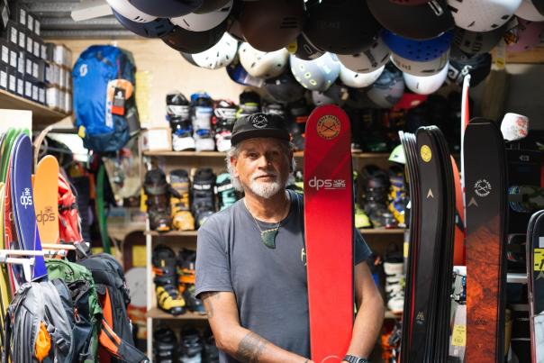 Portrait of Darryl Tatom, Owner of Small Planet in shop surrounded by winter sports gear