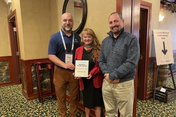 Diane Janes of Community Bank presented with the September 2023 Business of the Month Award Plaque by del Lago representative Lance Young and Seneca Meadows representative Mark Benjamin at the September Business After Hours event at Ciccino's Restaurant