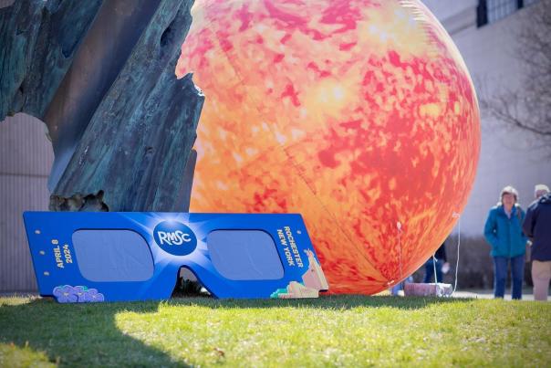 Oversized, Rochester branded eclipse glasses and inflatable sun
