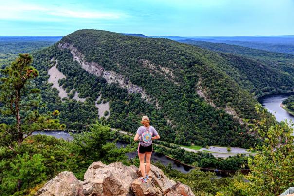 A hiker looks out over the Pocono Mountains along the Appalachian Trail