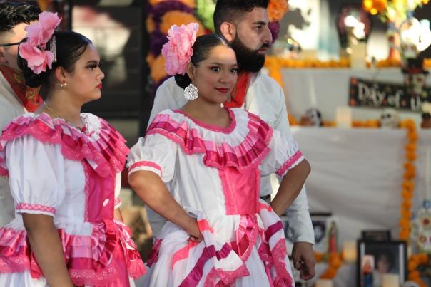 Latin dancers in traditional attire celebrating Hispanic Heritage Month in downtown Bentonville.