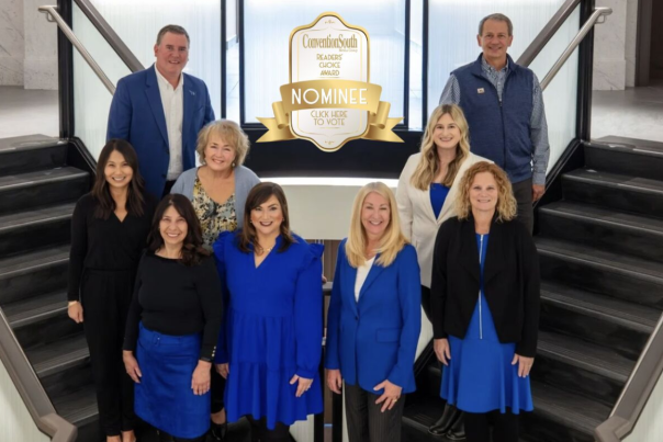 9 people standing on steps posing for photo